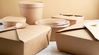 paper containers for takeaway food, isolated on a wooden table